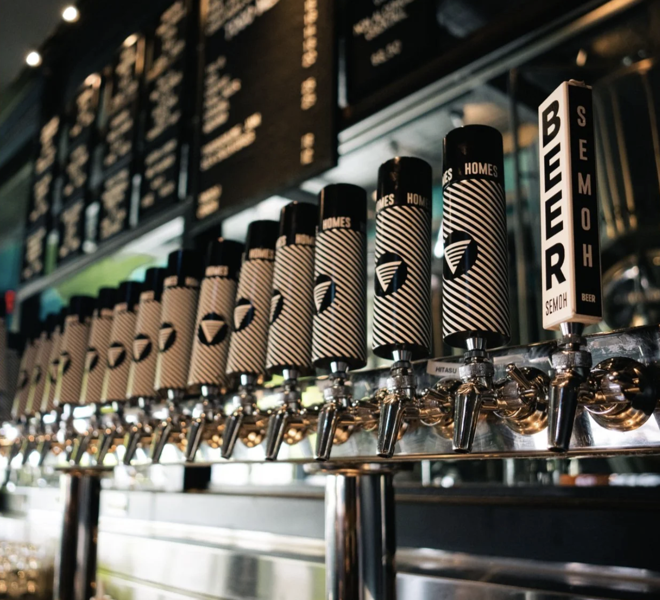The bar and taps at HOMES Brewery Brewpub in Ann Arbor, with craft beer being poured